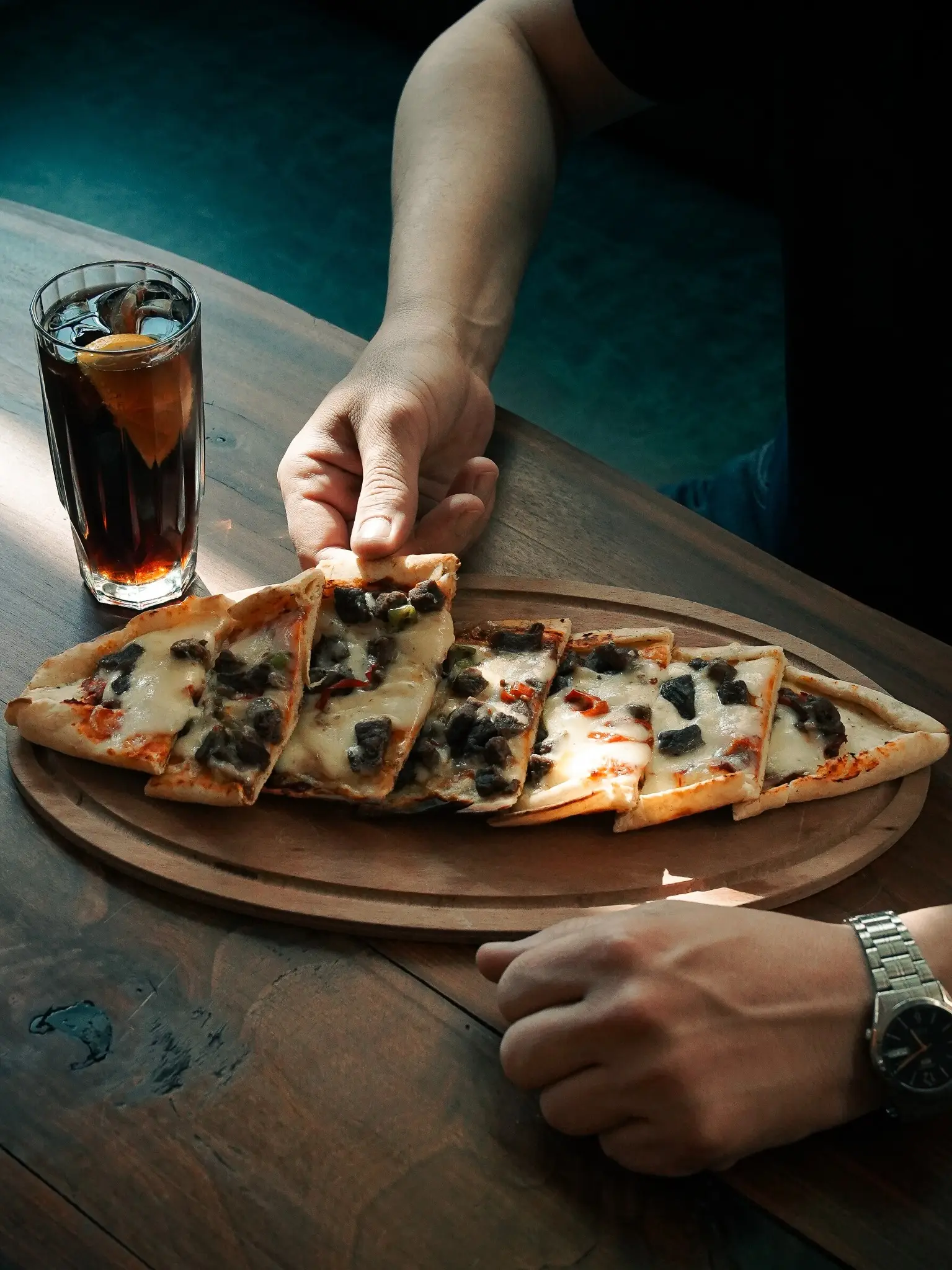 Freshly baked Turkish beef pide served on a wooden board at Chimney Bistro